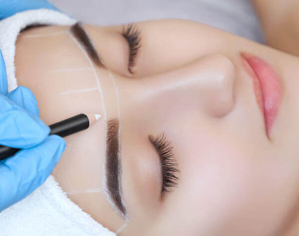 Woman Having Lines Drawn on Her Forehead