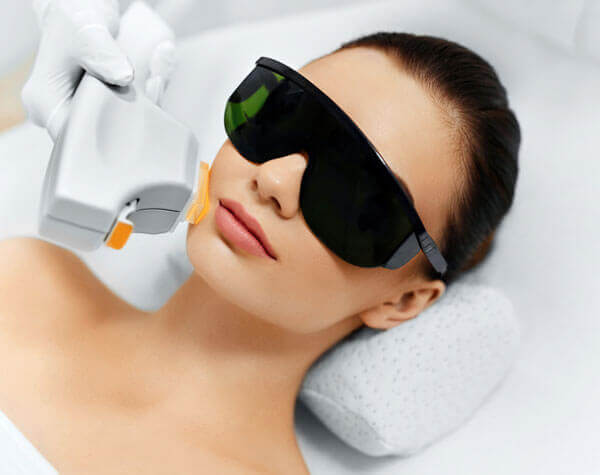 Woman With Sunglasses on Recieving a Treatment on Her Face