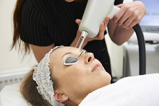 Woman undergoing cosmetic laser skin resurfacing 